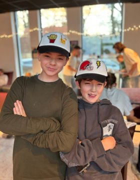 twee jongens tonen gepimpte pet workshop Hello Mojo Kortrijk pet pimpen creatieve workshop jongeren